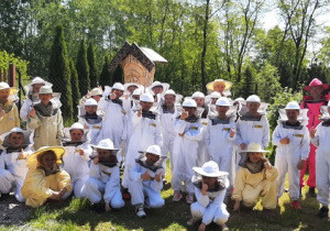 Zdjęcia grupowe w strojach pszczelarskich.